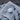 White course logo golf ball on a gray towel with a blurred wood background