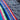 Close-up of the colorful sarape front side and dark textured fabric back side of the dark grey colorway.