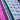 Close-up of the colorful sarape front side and dark textured fabric back side of the white colorway.